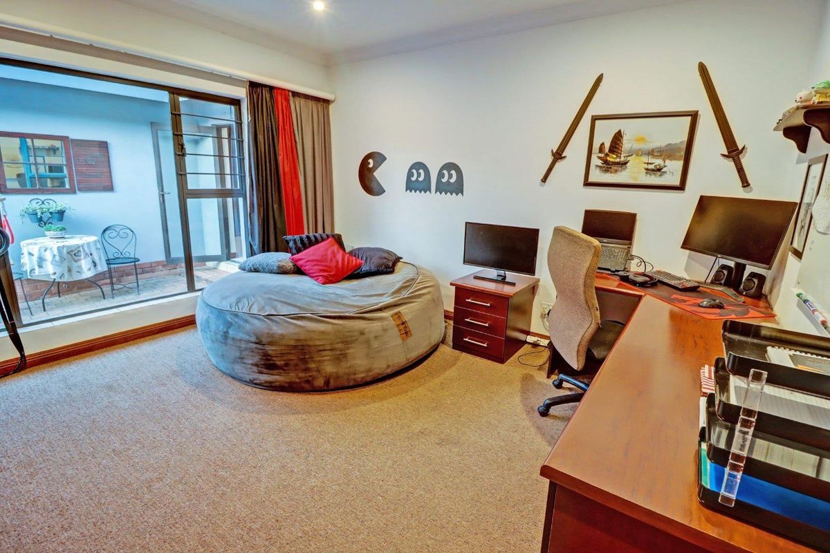 A bedroom featuring carpeted flooring, recessed lighting, and a large sliding glass door providing access to an outdoor patio area.