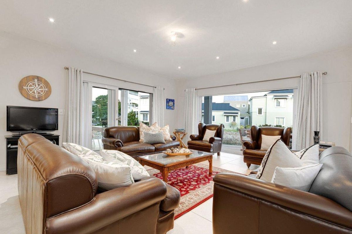 Spacious living room featuring large sliding glass doors that provide seamless access to the outdoor area and abundant natural light.