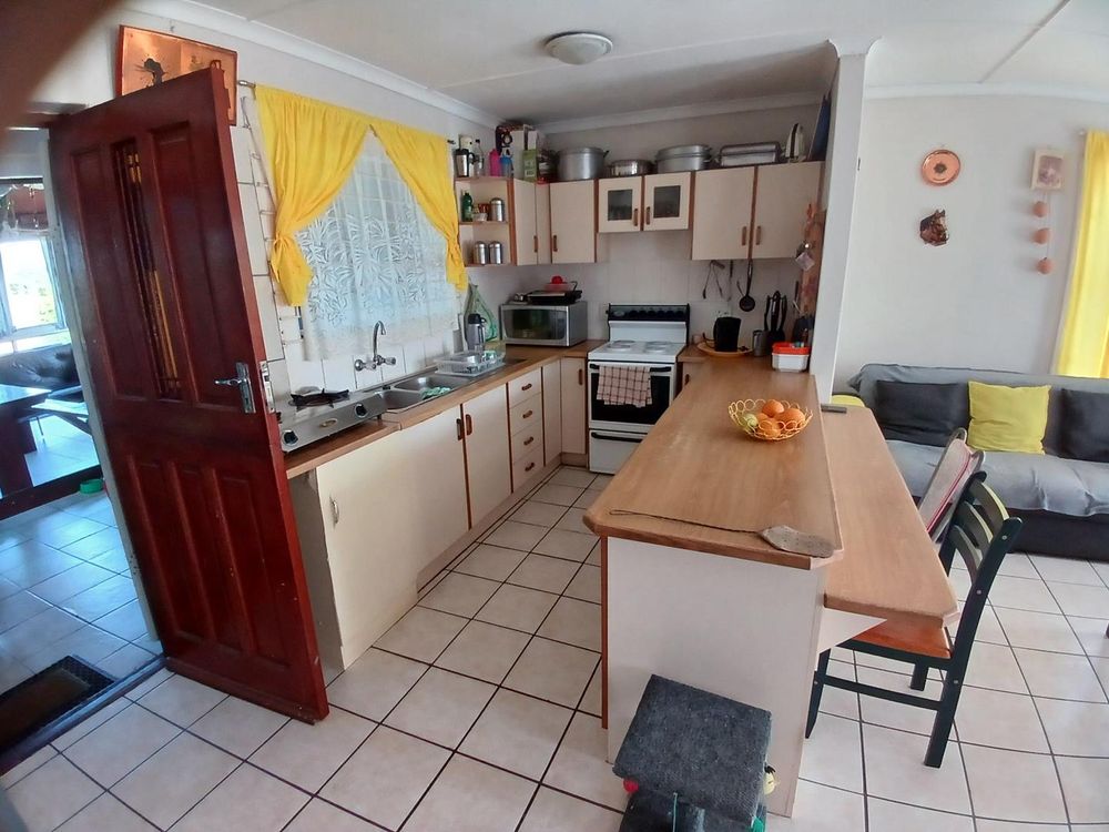 Kitchen itself - o/plan with Main Living Area. Entrance to 2nd Living/BBQ Area on left.