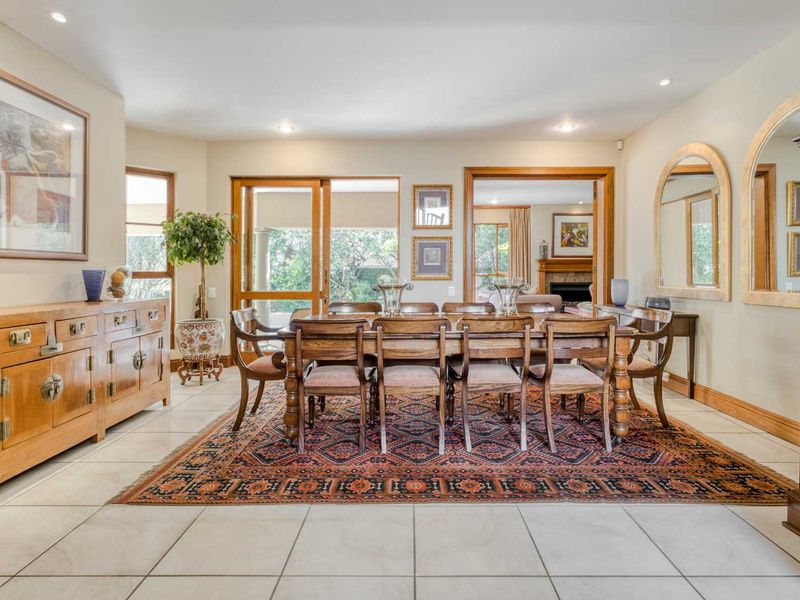 Spacious dining room featuring tiled flooring, recessed lighting, and large sliding glass doors providing access to the outdoor area.