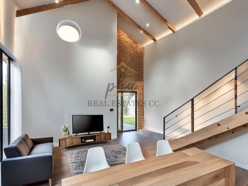 Spacious living area featuring a double-volume vaulted ceiling with exposed timber beams, a striking brick feature wall, and a modern timber staircase.