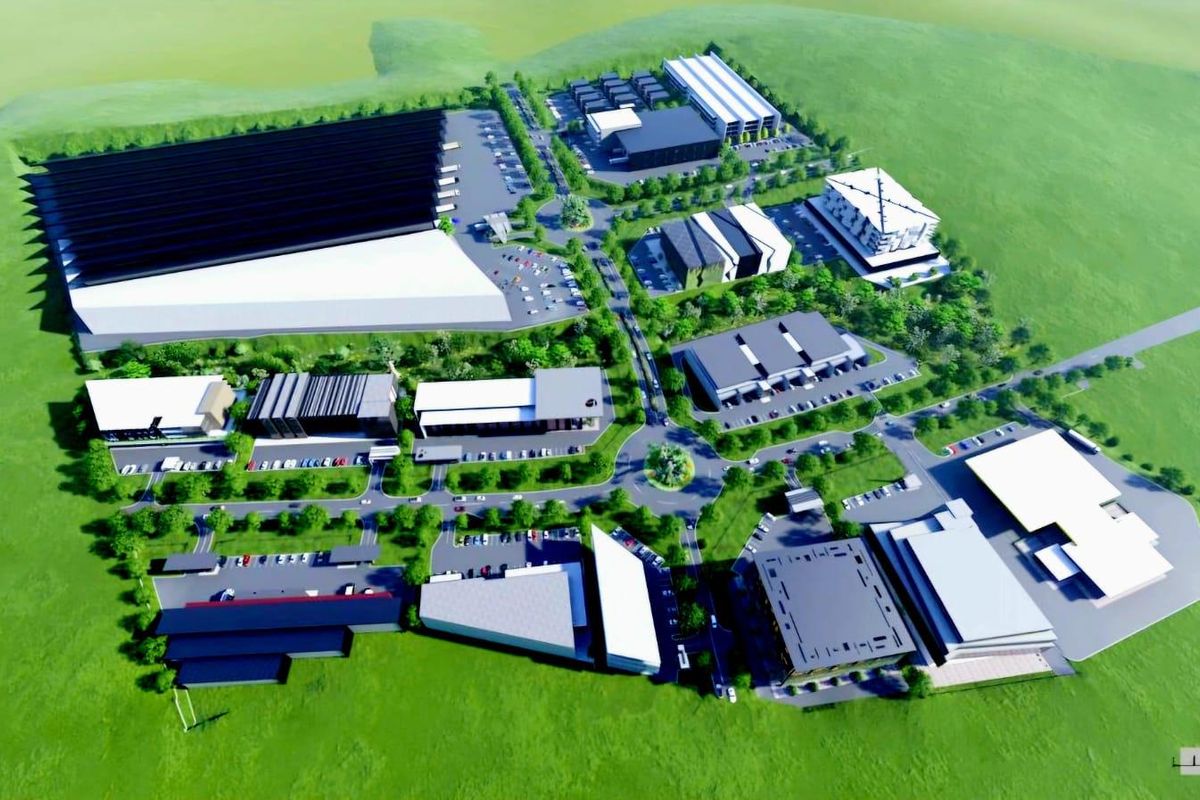 An aerial 3D architectural rendering of a proposed commercial business park development featuring multiple warehouse and office buildings with integrated parking and landscaping.