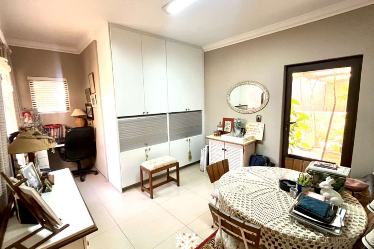 A multi-purpose room featuring built-in floor-to-ceiling cabinetry, tiled flooring, and a glass door providing access to an outdoor area.