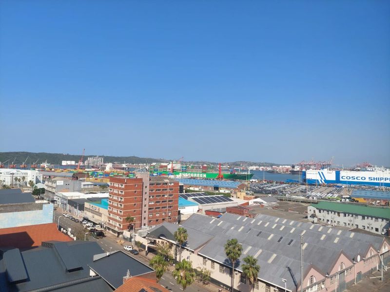 Elevated panoramic view overlooking the industrial harbour, shipping port, and surrounding urban cityscape.