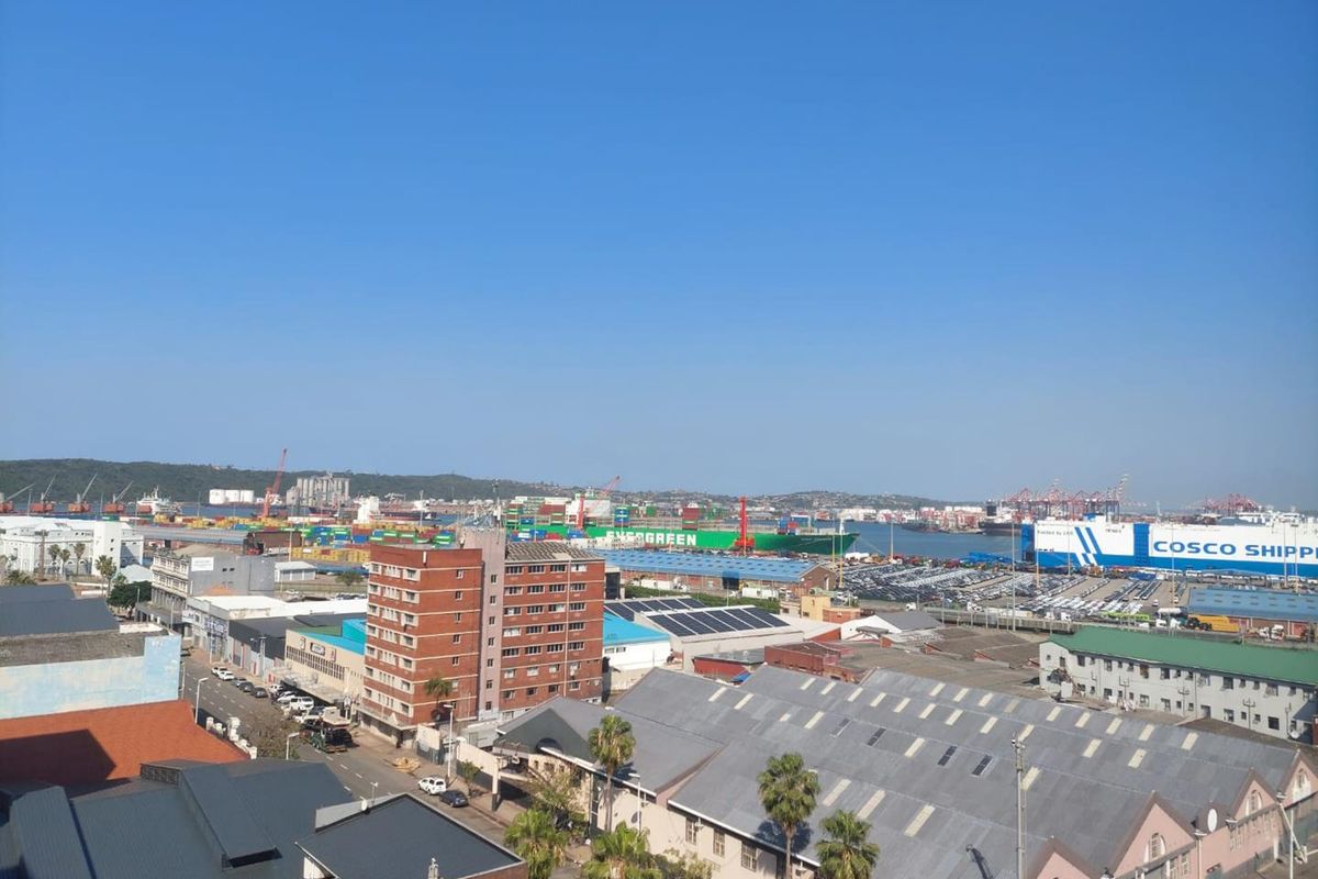 Elevated panoramic view overlooking the industrial harbour, shipping port, and surrounding urban cityscape.