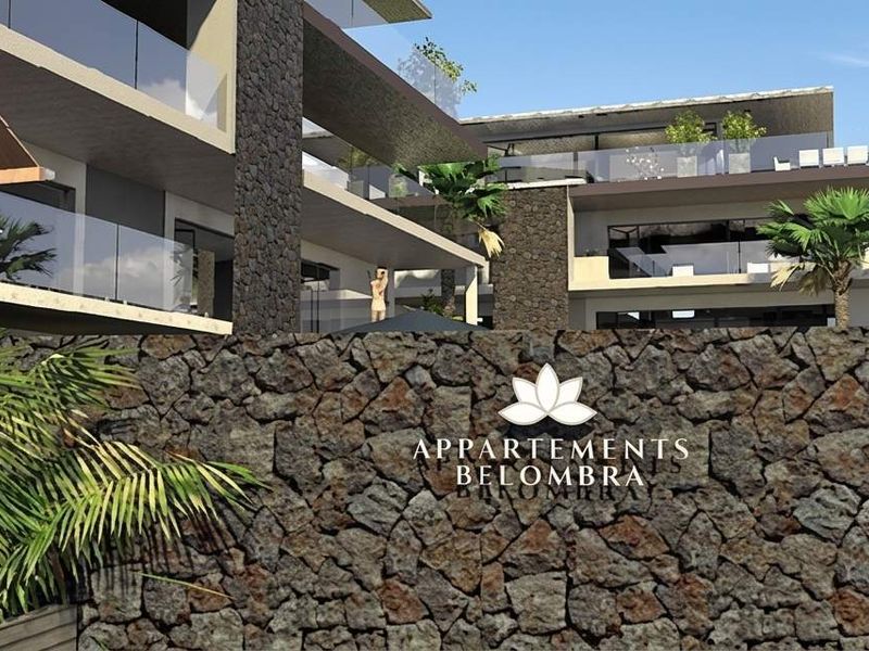 A modern penthouse exterior featuring stone wall cladding, multi-level balconies with glass balustrades, and contemporary architectural design.
