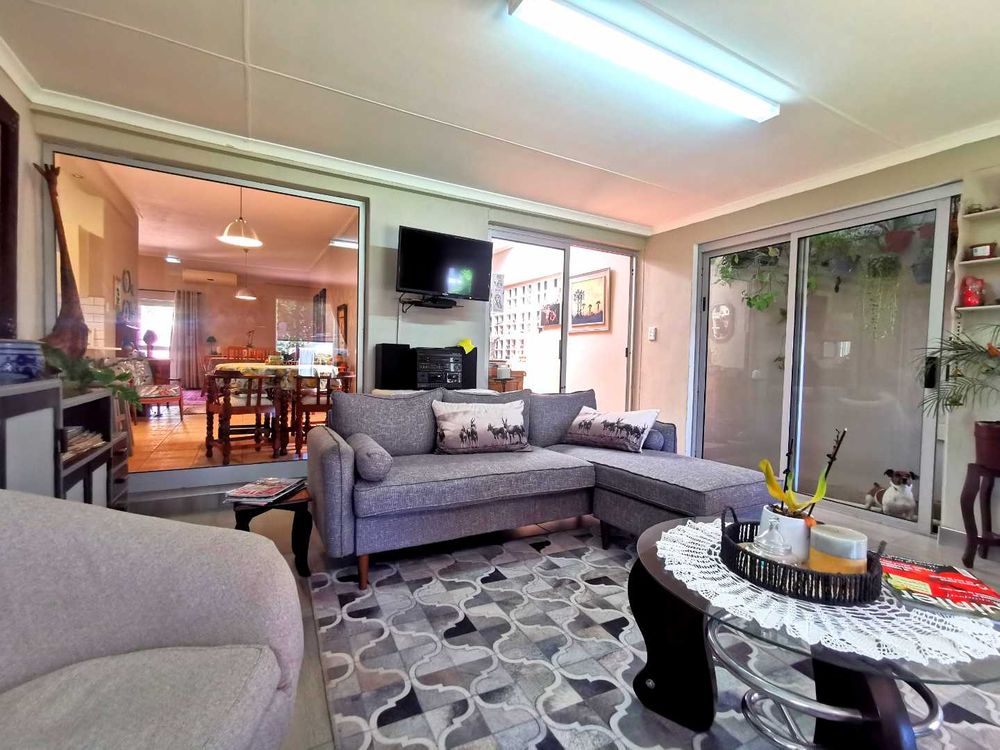 NEXT TO THE OPEN-PLAN KITCHEN WITH LOUNGE IS THIS INDOOR ENTERTAINMENT/FAMILY  ROOM WITH BUILT-IN BRAAI 