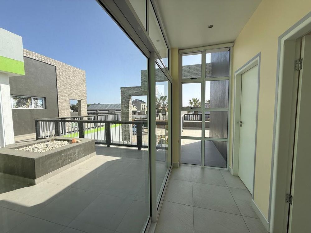 Connecting hallway to the other two bedrooms. Connecting balcony