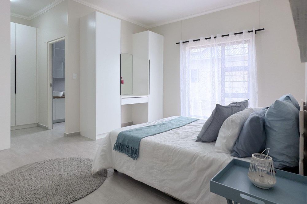 Large main bedroom with built-in cupboards, a dressing room and ensuite bathroom.