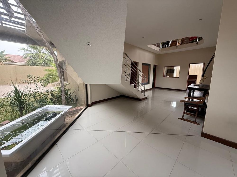 More of the entrance foyer, stairs and ground floor living area