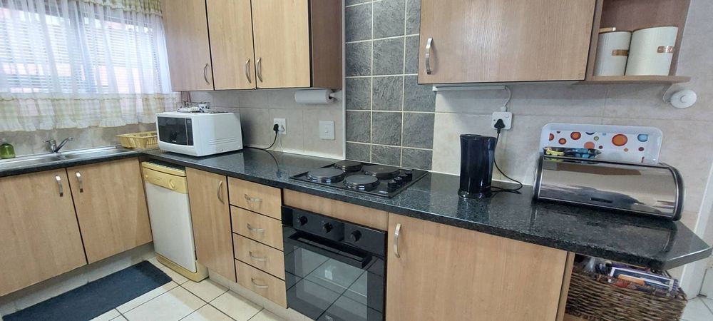 Kitchen with electric hob, extractor and oven