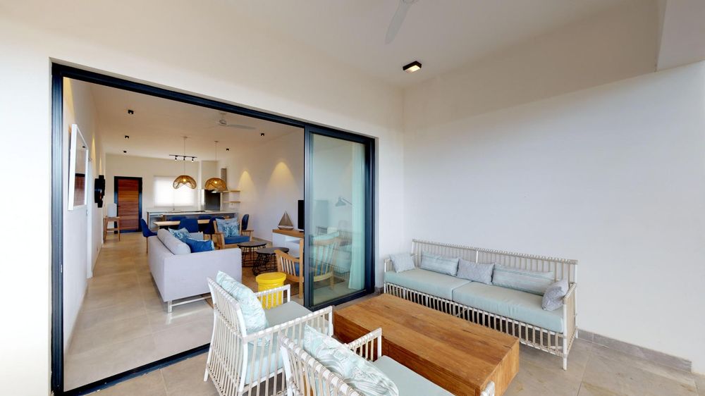 Patio with seating areas. Sliding doors leading to the lounge 