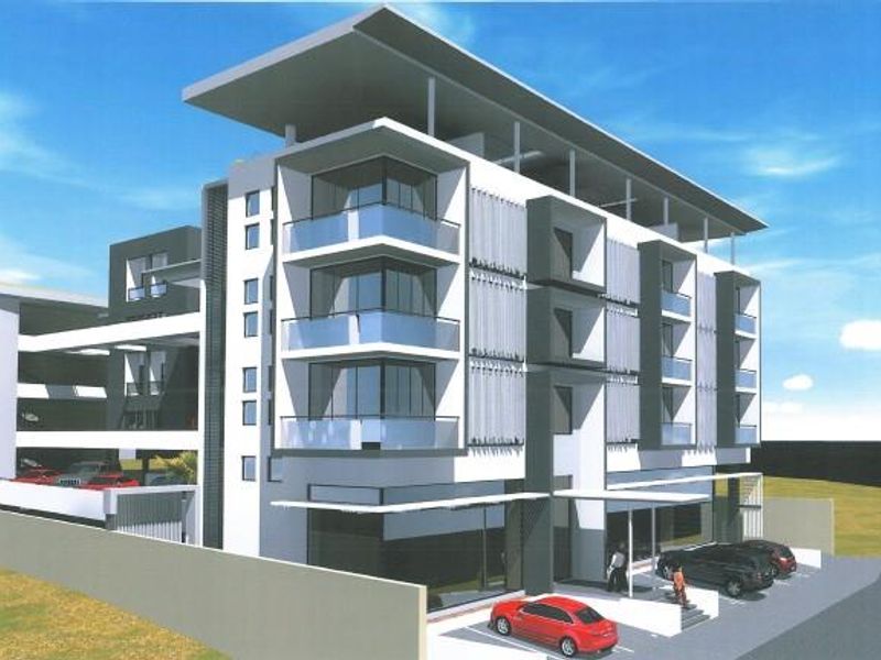 A modern multi-story office building featuring contemporary architectural design, glass balconies, and integrated covered parking facilities.