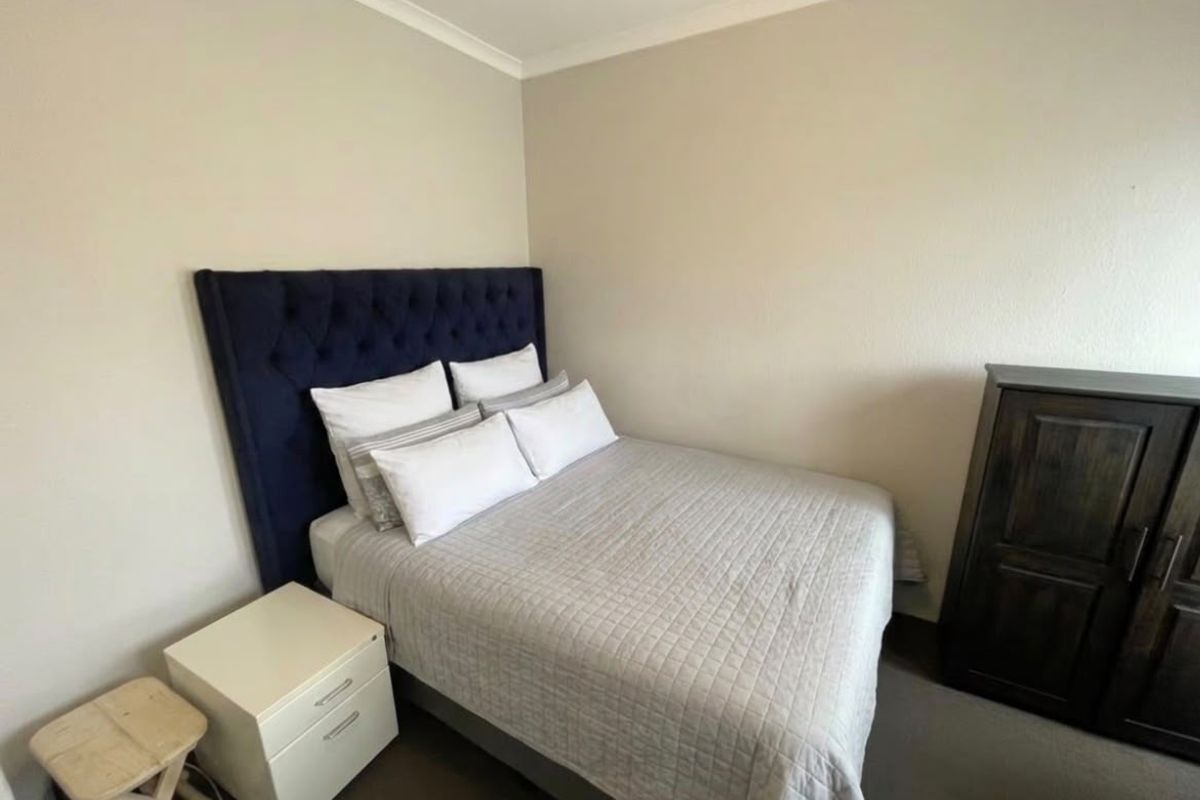 A standard bedroom featuring neutral wall finishes and coving detail.