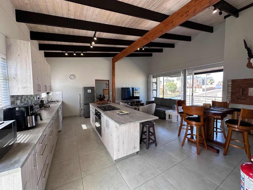 Main Flat, 2 ensuite bedrooms, open plan kitchen with lounge and inside barbecue and balcony.