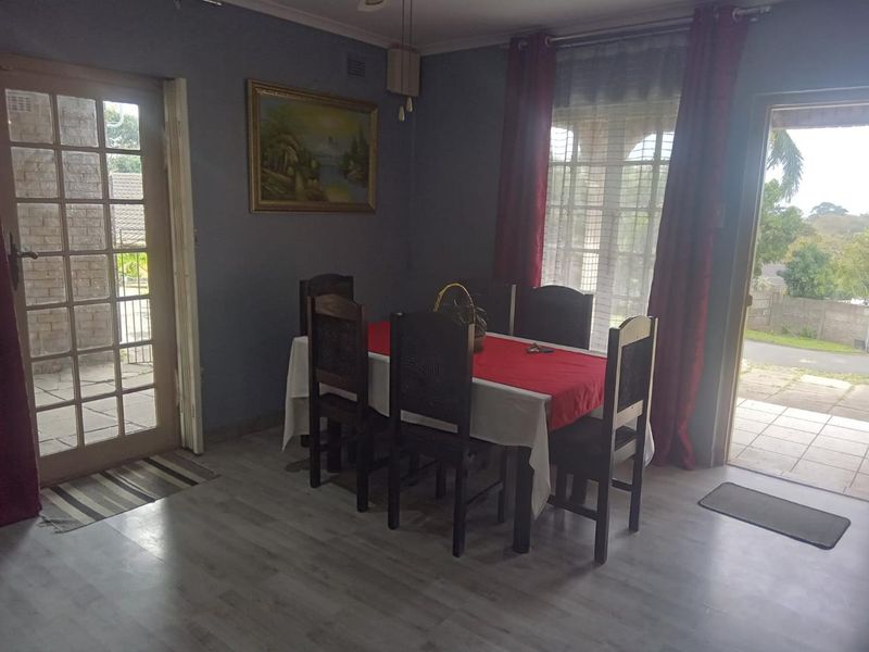 Dining room featuring laminate flooring and dual access points via french doors, providing natural light and direct access to the exterior.