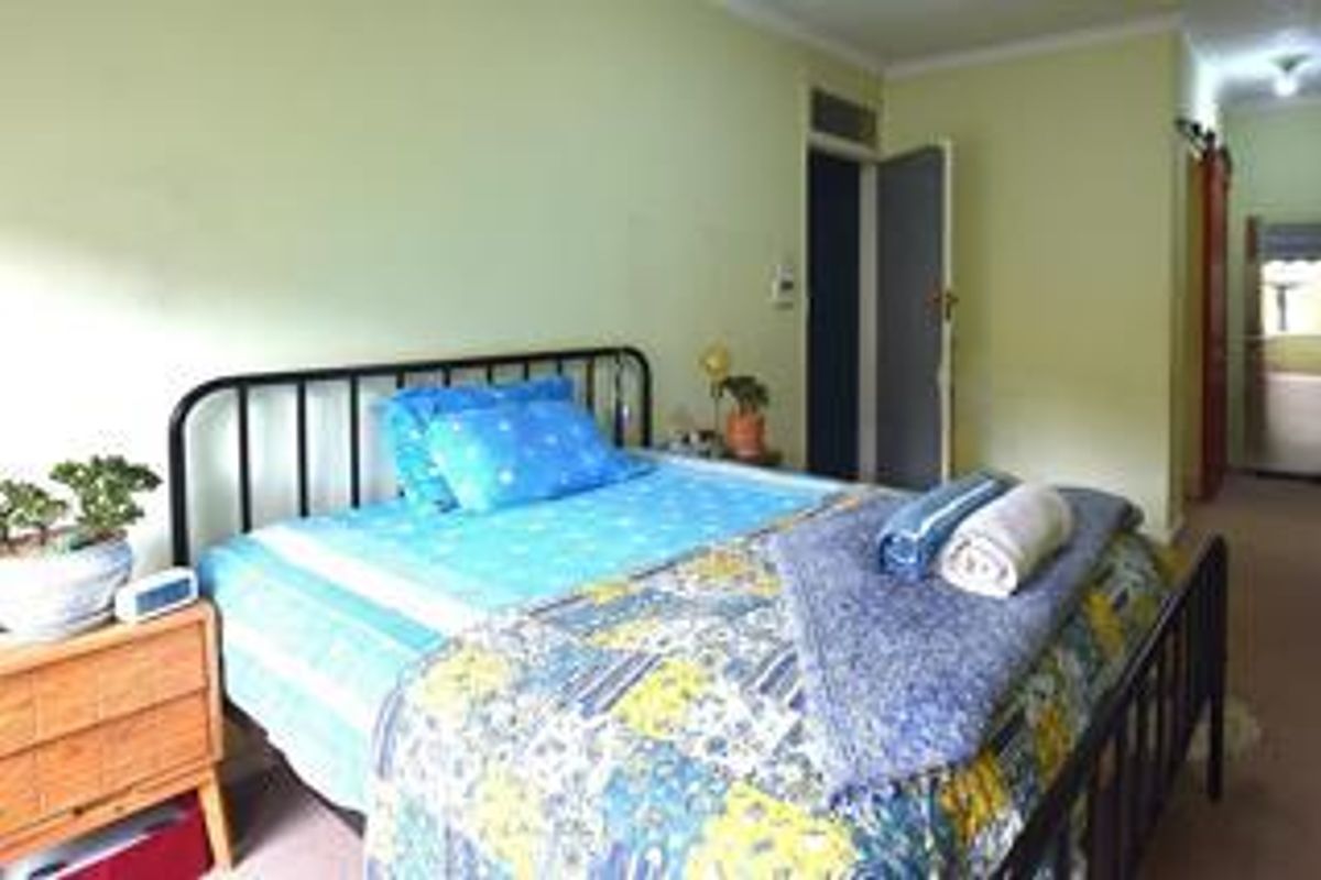 A standard bedroom featuring carpeted flooring and neutral wall finishes, providing a functional and comfortable living space.