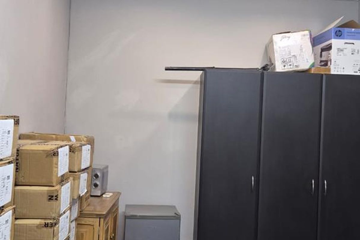 A functional utility or storage space featuring recessed ceiling lighting, an air conditioning unit, and tiled flooring.