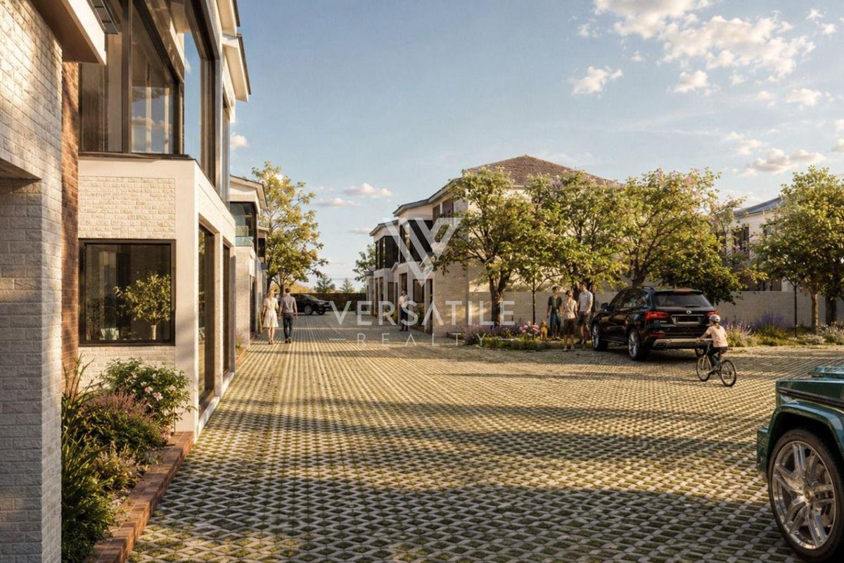 A modern residential complex featuring brick facades and a spacious paved driveway area, showcasing contemporary architectural design and well-maintained outdoor surroundings.