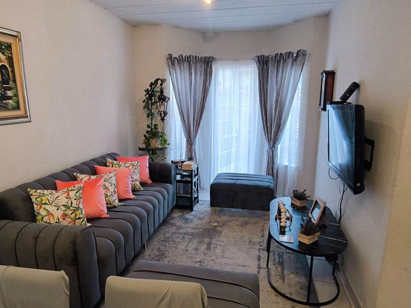 A cozy living room featuring a sliding glass door that provides natural light and access to the outdoor area.