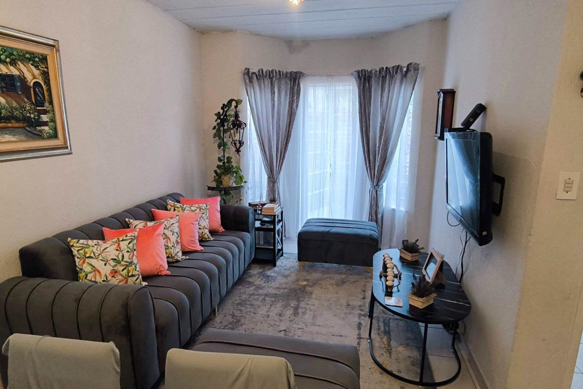 A cozy living room featuring a sliding glass door that provides natural light and access to the outdoor area.