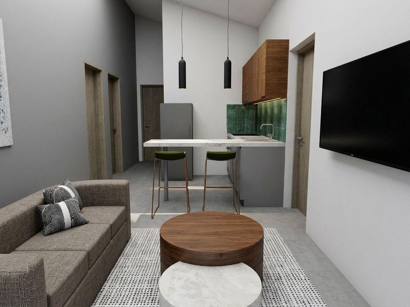 Modern open-plan living area featuring a compact kitchen with stone breakfast bar, sleek cabinetry, and contemporary finishes throughout.