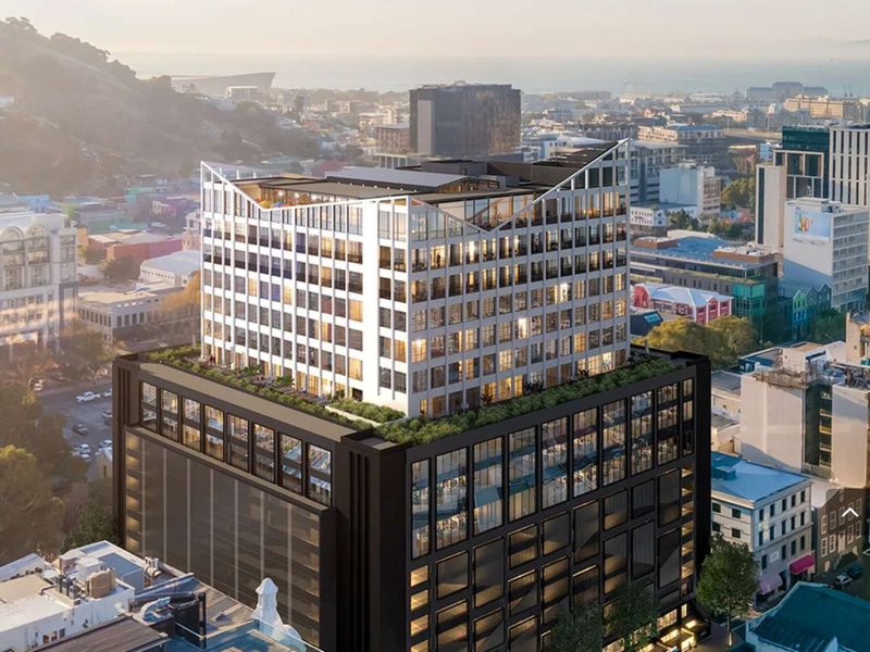 An aerial perspective of a modern multi-story office building featuring a distinctive rooftop terrace, glass facade, and integrated parking facilities in an urban setting.