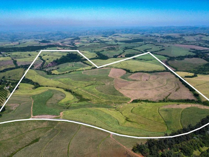 Aerial view of a large agricultural farm property with clearly marked boundary lines, showcasing expansive fields and rural landscape.