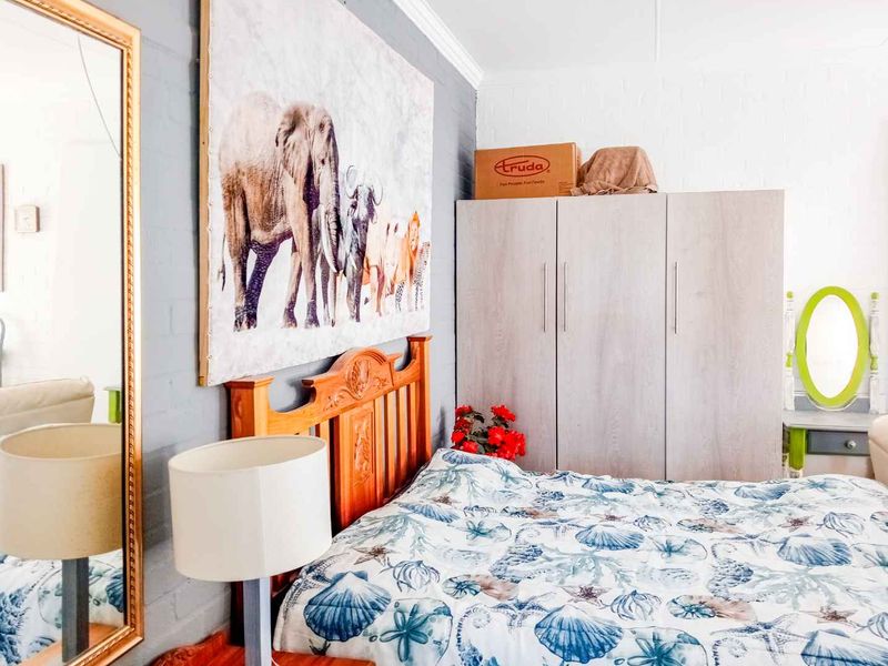 A bedroom featuring a built-in wardrobe and crown molding, providing functional storage and classic architectural detailing.