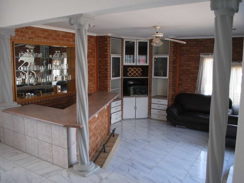 Renovated, built up, and expanded into a neat four-bedroom home with multiple living rooms and Bar area - Photo 6