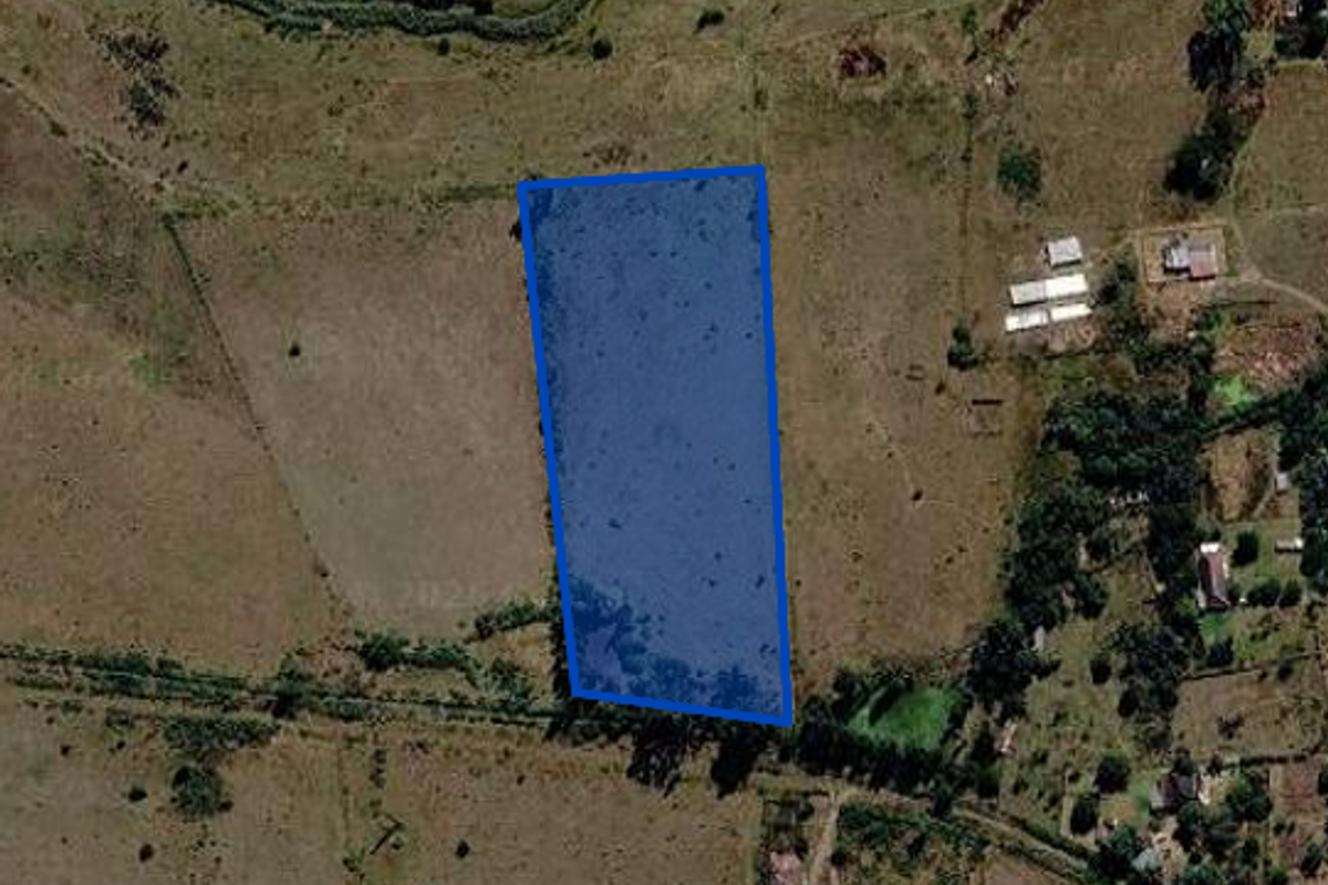 An aerial satellite view showing a highlighted rectangular plot of land situated within a rural or semi-rural landscape.