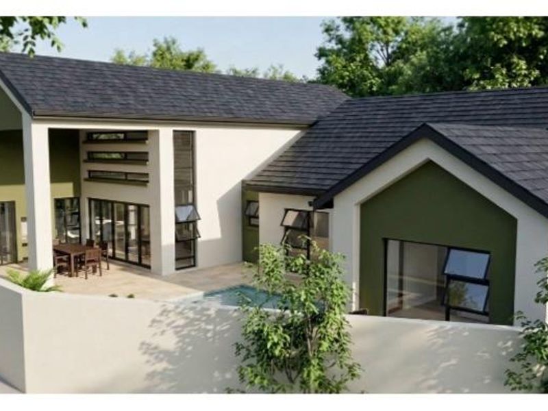 A modern residential exterior featuring a tiled roof, covered patio area, and a private swimming pool enclosed by a boundary wall.