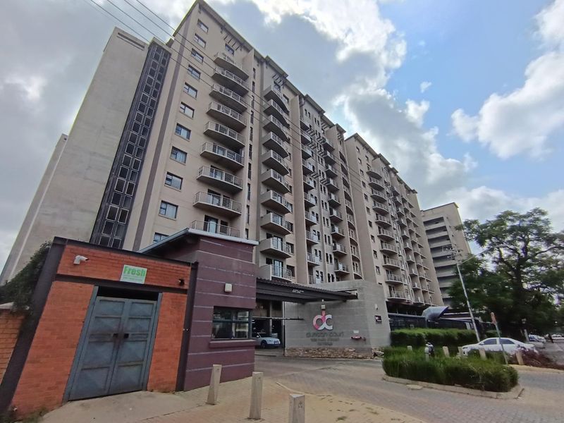 Exterior view of Duncan Court apartment complex featuring a multi-story residential building with balconies and a secure gated entrance.