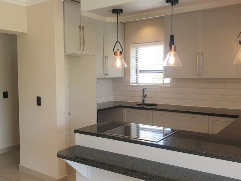 Swing Into Style: Sunlit 1st Floor Haven with Designer Kitchen in Golf Estate - Photo 5