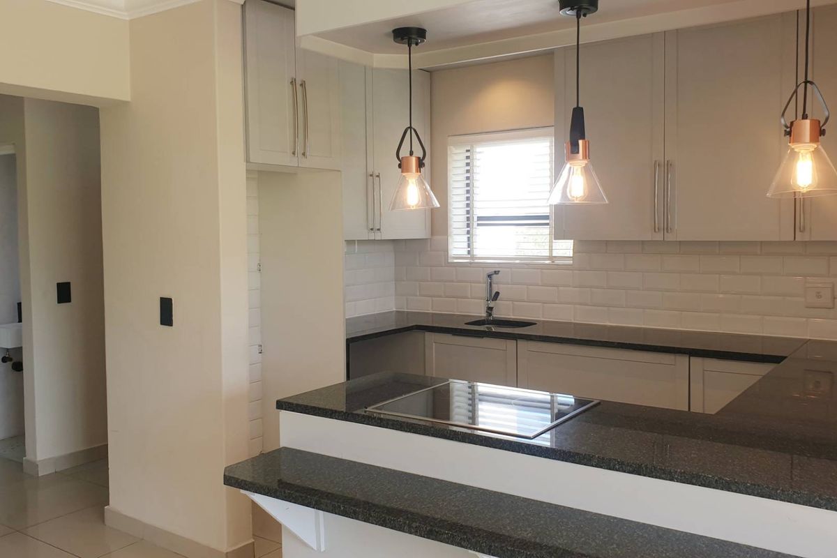 Swing Into Style: Sunlit 1st Floor Haven with Designer Kitchen in Golf Estate - Photo 5