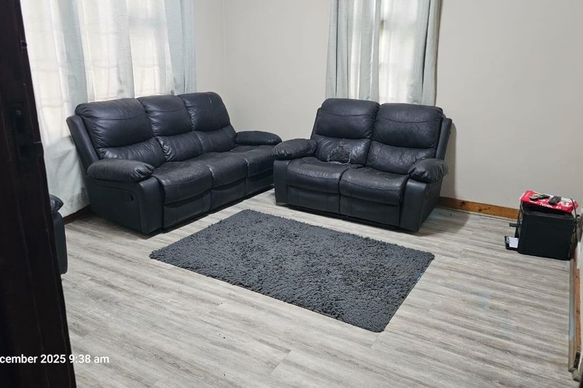 A living room featuring light-toned laminate flooring and neutral wall finishes, providing a functional and versatile space for relaxation.