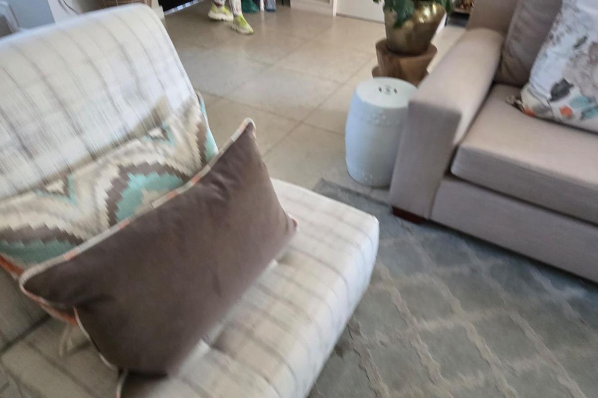 A view of a living area featuring tiled flooring and neutral wall finishes.
