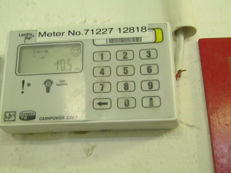 A wall-mounted Landis+Gyr prepaid electricity meter unit with visible wiring connections.