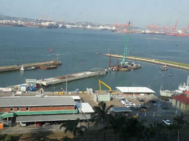 Elevated harbour and industrial port view overlooking the waterfront, surrounding infrastructure, and coastal landscape.