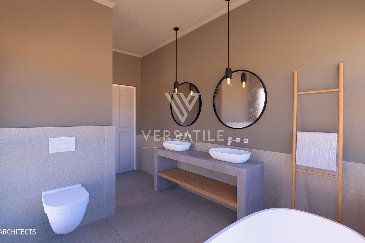 Modern bathroom featuring a double vanity with vessel sinks, wall-mounted toilet, and contemporary pendant lighting in a neutral color palette.