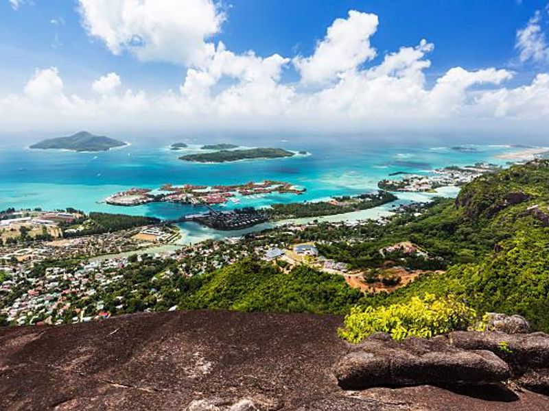 A breathtaking elevated aerial view overlooking the coastal landscape, turquoise waters, and surrounding islands, showcasing the natural beauty of the property's location.