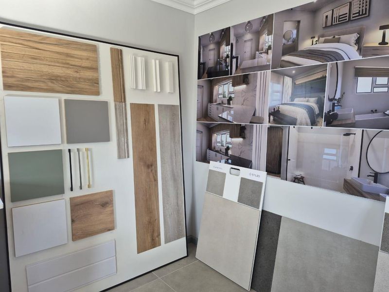 A display area showcasing various interior design material samples, including wood finishes, tiles, and cabinet hardware, alongside a collage of finished room concepts.