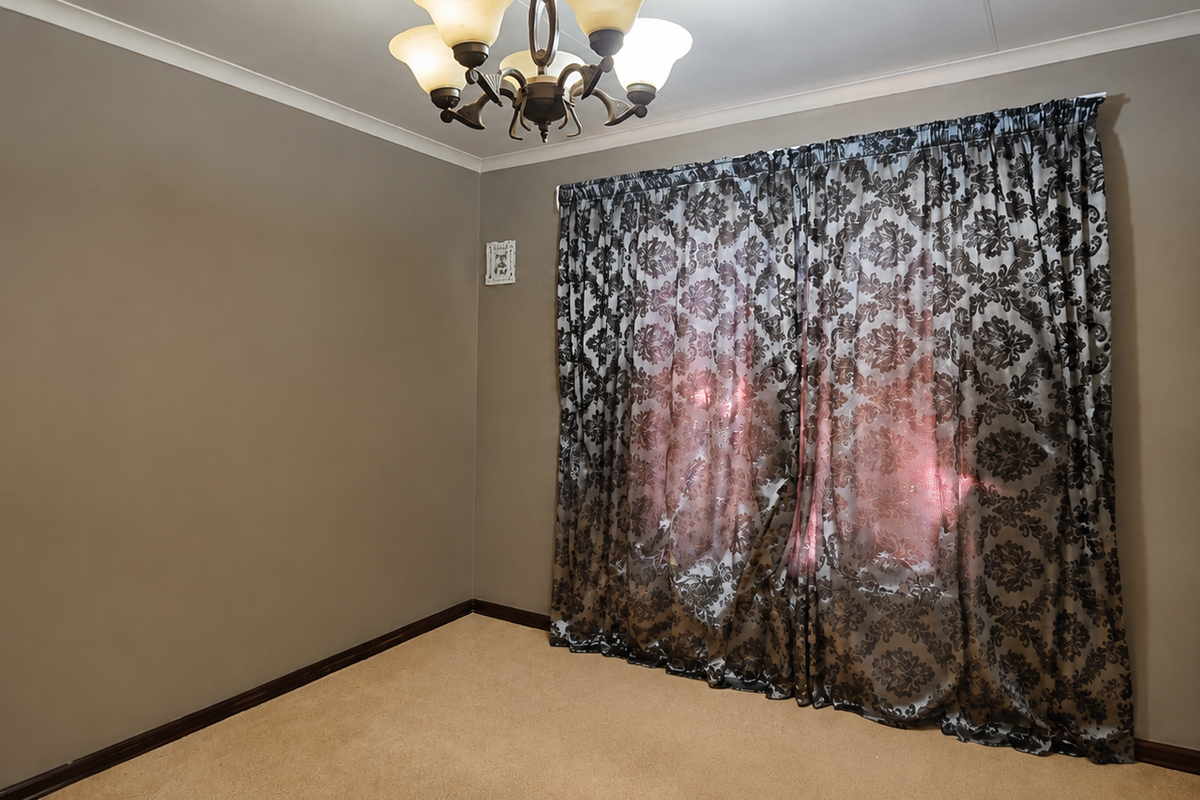 A neutral-toned bedroom featuring carpet flooring, coving, and a built-in wardrobe, offering a clean and versatile space.