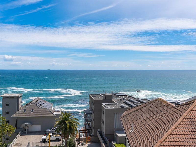 A clear, elevated view of the ocean and surrounding coastal neighborhood, showcasing the property's prime location and scenic outlook.