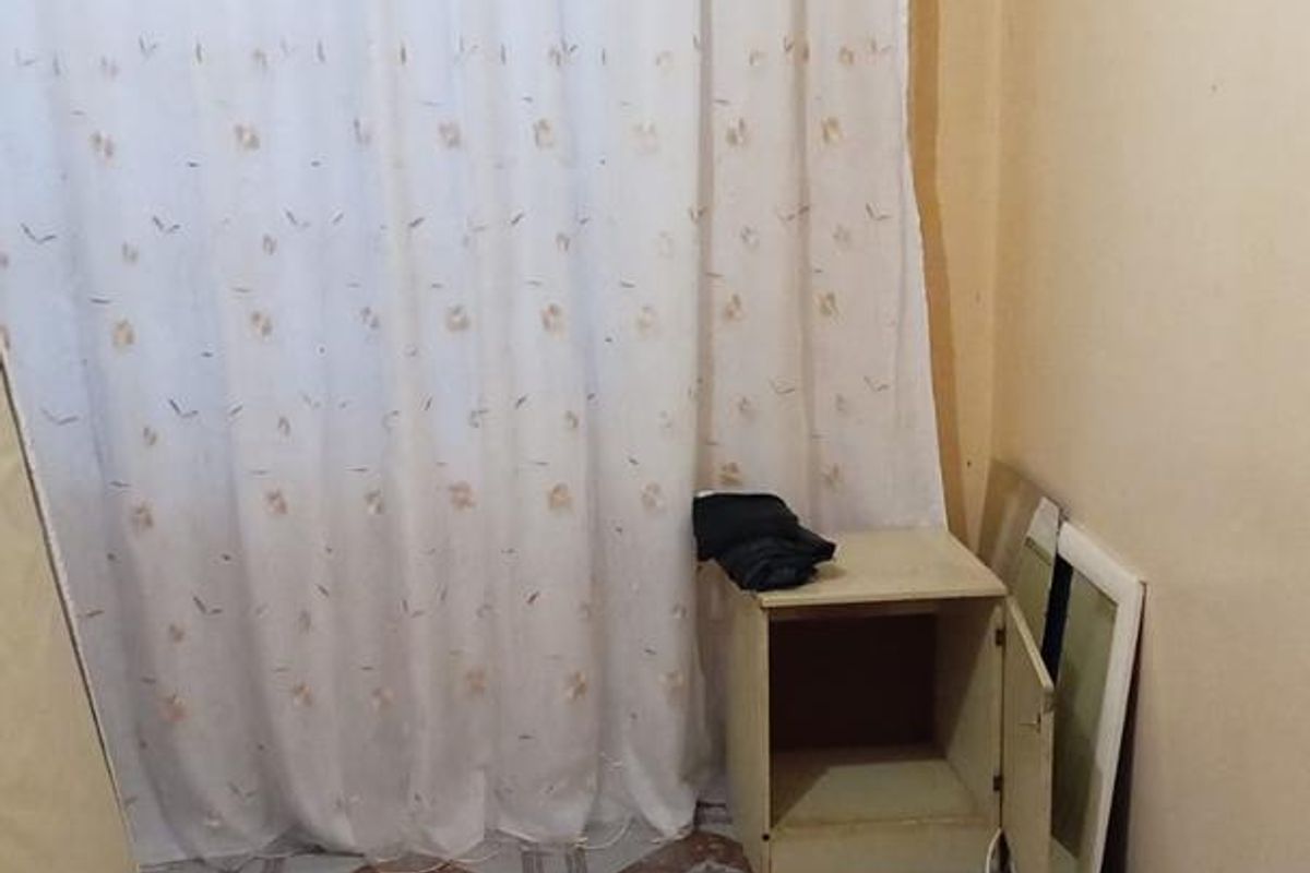 A small bedroom featuring tiled flooring and a curtain rail, currently vacant and in need of cosmetic updates to improve its overall condition.