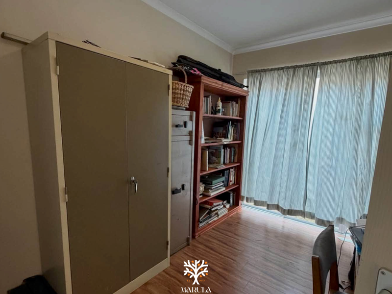 A bedroom featuring laminate flooring, cove cornicing, and a sliding glass door providing access to the exterior.