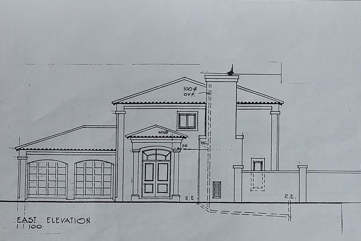 Architectural east elevation drawing for a residential property, detailing the facade, garage, and chimney structure.