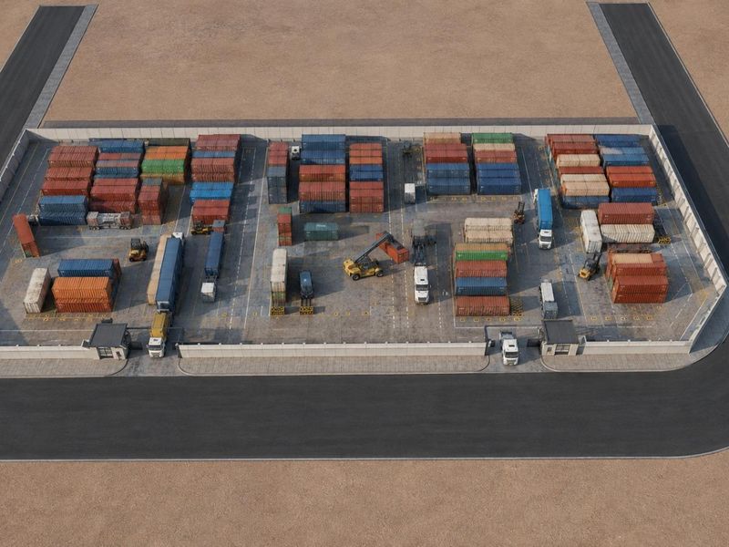 Aerial view of a secure industrial container storage yard featuring paved surfaces, perimeter fencing, and dual access gates.