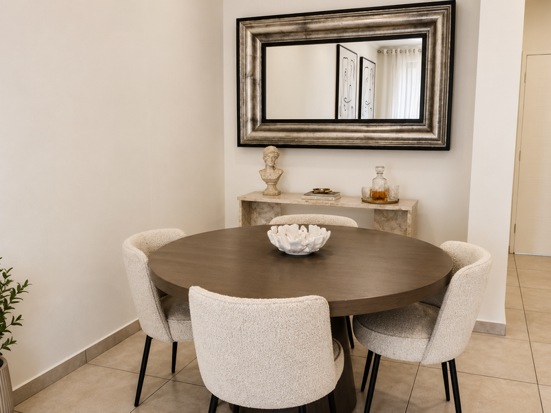 A well-maintained dining area featuring neutral tiled flooring and a clean, modern aesthetic, providing a functional space for meals.