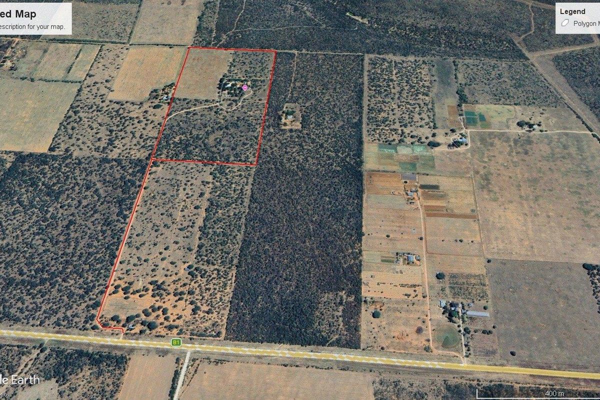 An aerial view of a large rural small holding property, showing the land boundaries, access roads, and surrounding agricultural landscape.